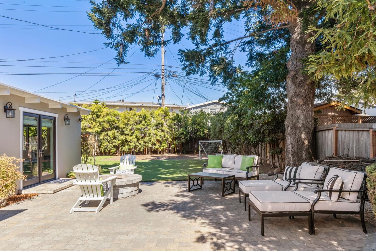 916 Linden Avenue Burlingame, CA 94010 - Photo 39 of 56 a backyard of a house with a table and chairs