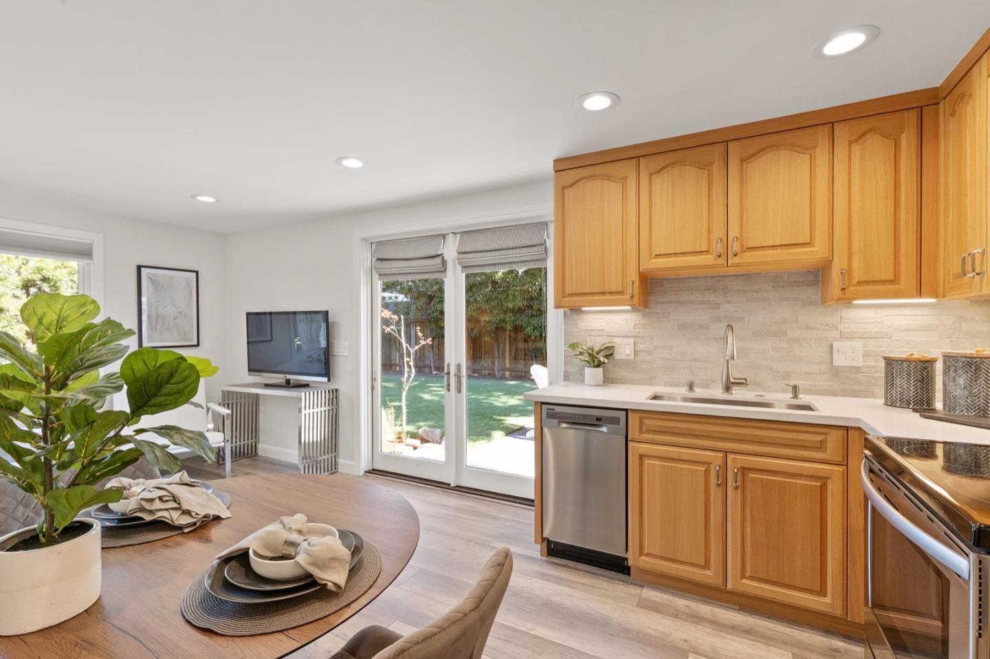 916 Linden Avenue Burlingame, CA 94010 - Photo 54 of 56 a kitchen with stainless steel appliances granite countertop a sink a stove and a wooden cabinets