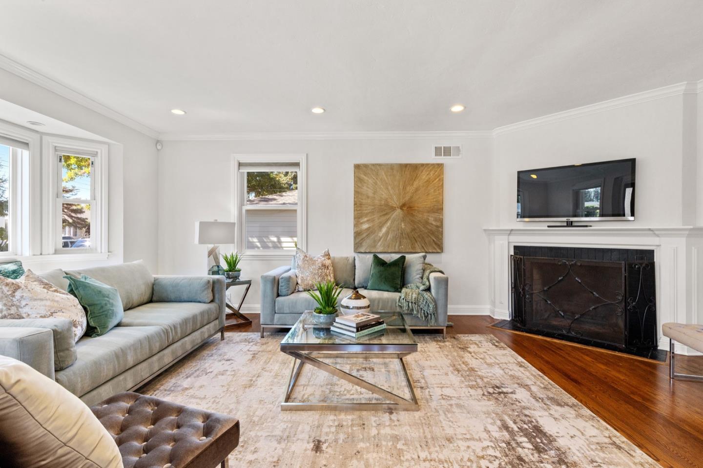 916 Linden Avenue Burlingame, CA 94010 - Photo 8 of 56 a living room with furniture a fireplace and a flat screen tv