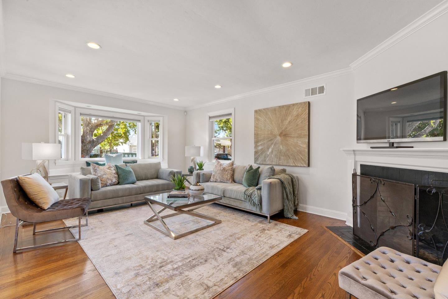 916 Linden Avenue Burlingame, CA 94010 - Photo 9 of 56 a living room with furniture a fireplace and a flat screen tv