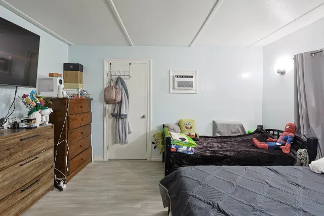 a bedroom with a bed and flat screen tv
