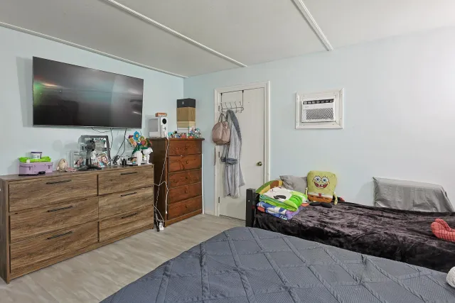 a bedroom with a bed and a mirror