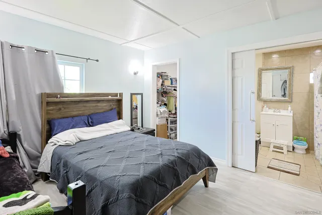 a bedroom with a bed and a flat tv screen