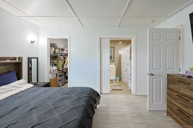 a bathroom with a granite countertop toilet sink and mirror