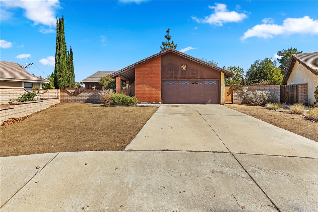 10426 Pima Court Riverside, CA 92503 - Photo 1 of 1 a front view of a house with a yard and garage