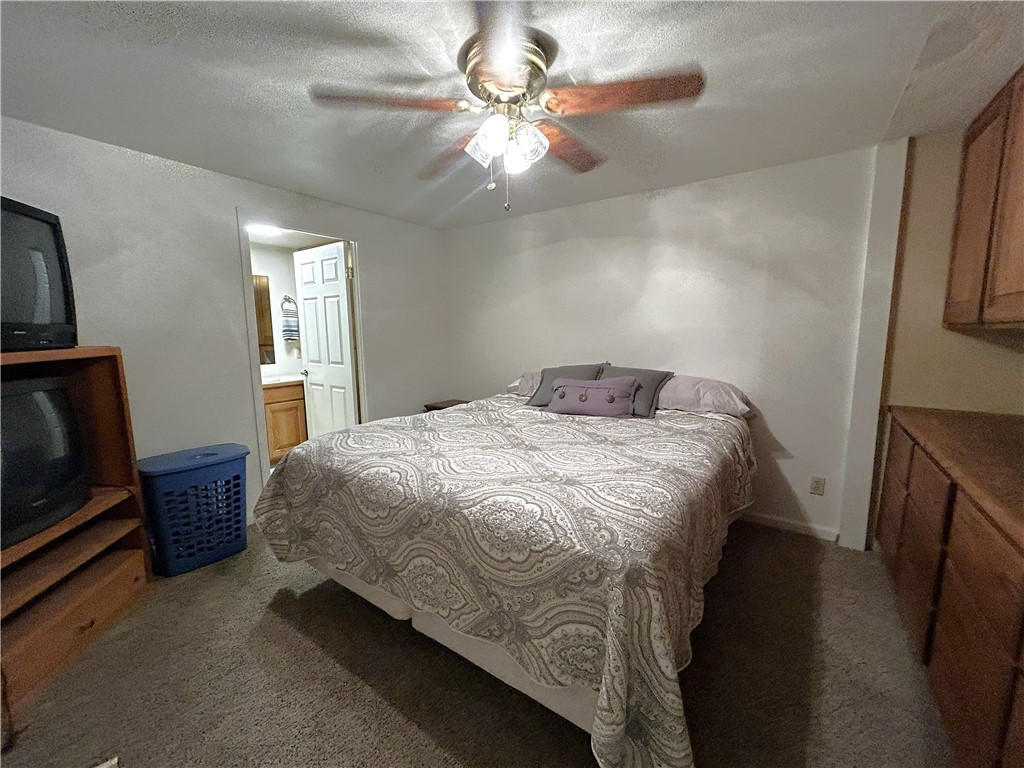 65 2nd Street Needles, CA 92363 - Photo 12 of 14 a bedroom with a bed and a flat tv screen on dresser
