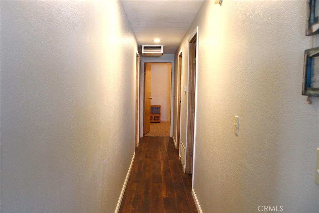 65 2nd Street Needles, CA 92363 - Photo 8 of 14 a view of a hallway with wooden floor and a bathroom