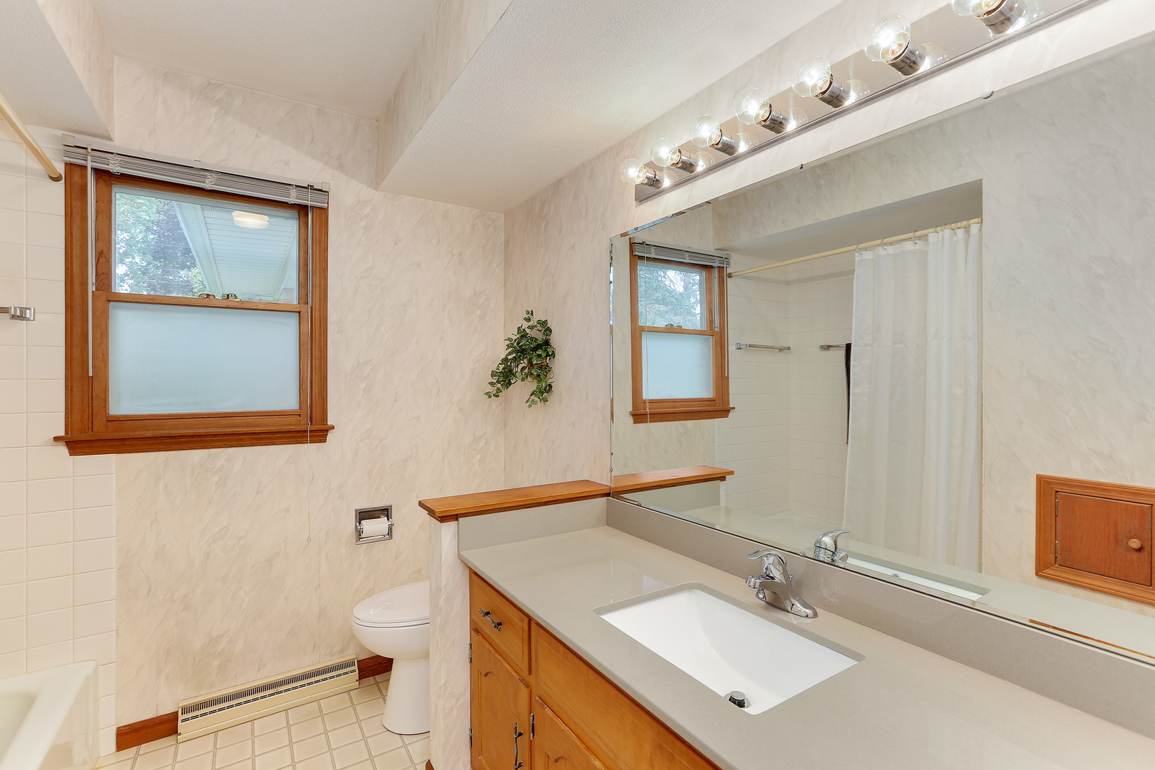 352 North Alfred Avenue Elgin, IL 60123 - Photo 14 of 20 a bathroom with a sink vanity mirror and toilet