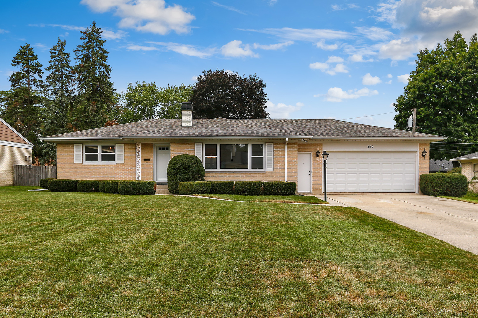 352 North Alfred Avenue Elgin, IL 60123 - Photo 20 of 20 a front view of house with yard and trees in the background