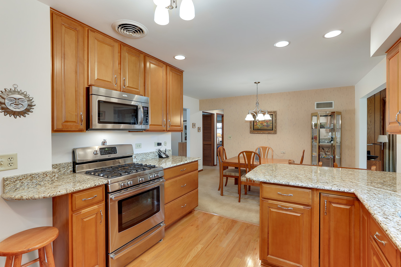 352 North Alfred Avenue Elgin, IL 60123 - Photo 7 of 20 a kitchen with stainless steel appliances granite countertop a sink stove microwave and cabinets