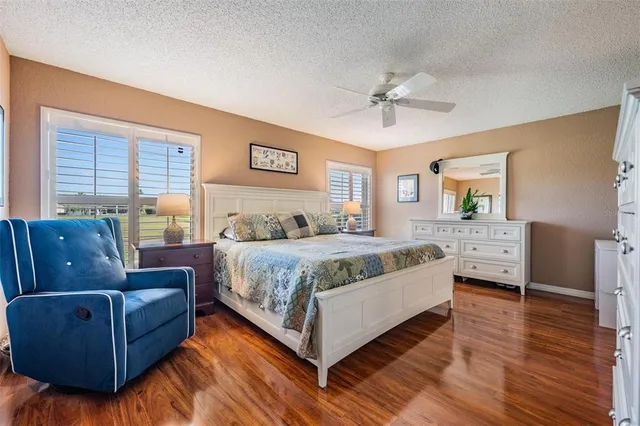 a spacious bedroom with a bed couch and window