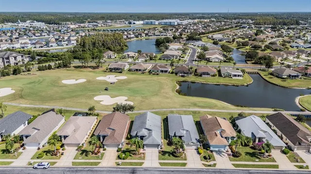 an aerial view of a house with yard swimming pool and outdoor seating