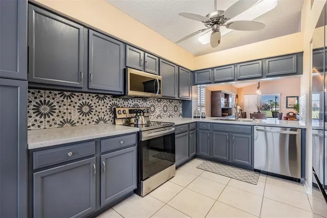 a kitchen with stainless steel appliances granite countertop a sink and cabinets