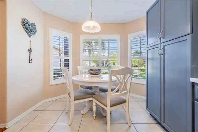a dining room with furniture a chandelier and window