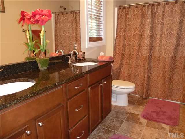 212 Bickett Boulevard Raleigh, NC 27608 - Photo 13 of 20 Spacious guest bath with 36" dual vanities and tile floor.