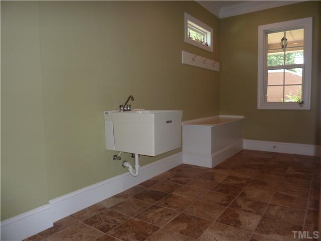 212 Bickett Boulevard Raleigh, NC 27608 - Photo 14 of 20 Optional 1st floor laundry room with a sink and storage seat. You could also put a 2nd refrigerator or deep freeze here or just use it as a mud room.