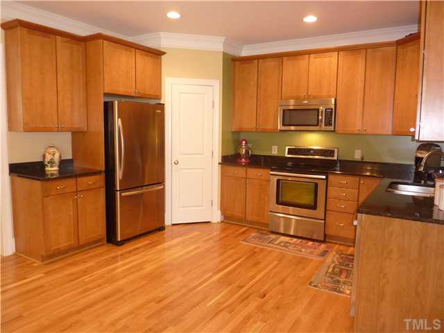 212 Bickett Boulevard Raleigh, NC 27608 - Photo 15 of 20 Another view of this beautiful kitchen showing the corner pantry and stainless steel refrigerator which is yours to keep!