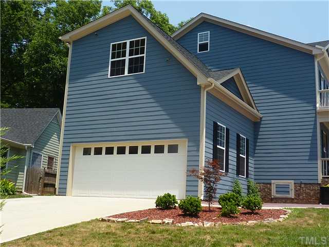 212 Bickett Boulevard Raleigh, NC 27608 - Photo 17 of 20 Nearly impossible to find in this neighborhood -a 2 car garage! This side entry garage features a large shelf/rack for plenty of storage, built-in cabinets, an exterior door off the side, & leads straight into the tiled mudroom w/ sink and laundry hookup.