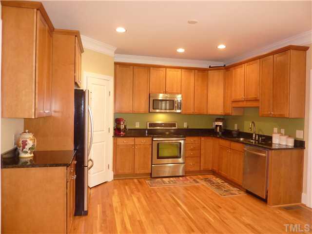 212 Bickett Boulevard Raleigh, NC 27608 - Photo 3 of 20 Extremely spacious kitchen features all stainless steel appliances, granite counter tops, 42" maple cabinets, hardwood floors, crown molding, and a large corner pantry. There's plenty of space to add an island if you like.