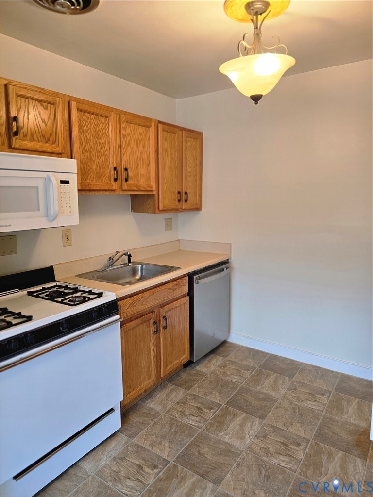 5610 Crenshaw Road, Unit 1221 Richmond, VA 23227 - Photo 6 of 14 a kitchen with a stove cabinets and a window