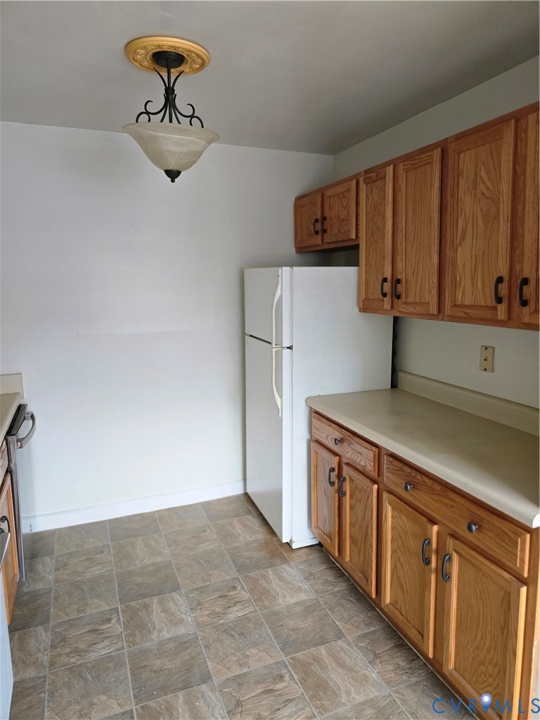 5610 Crenshaw Road, Unit 1221 Richmond, VA 23227 - Photo 7 of 14 a kitchen with a stove and a refrigerator