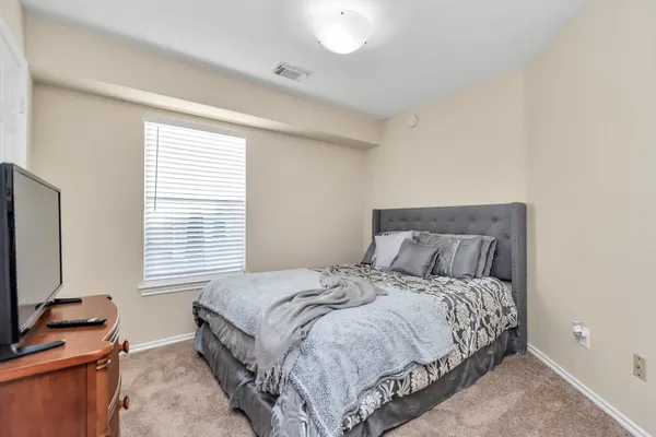 a bed sitting in a bedroom next to a window