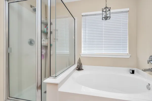 a white bath tub sitting next to a window