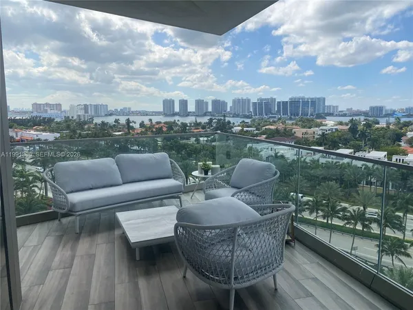 a view of a roof deck with couches and wooden floor