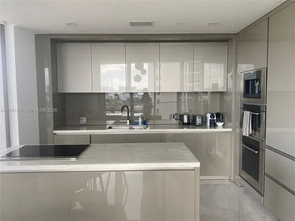 a kitchen with a refrigerator a stove a sink and a window