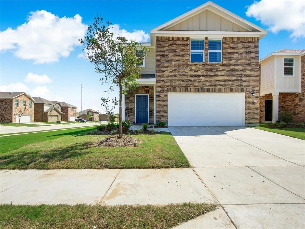 1908 Marquette Road Princeton, TX 75407 - Photo 1 of 14 Brick facade two-story residence featuring a prominent garage door, a blue front entry door, and a concrete driveway