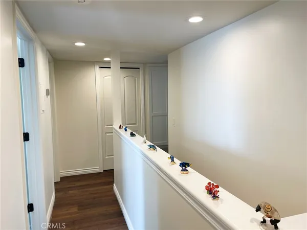 a room with water heater and wooden cabinets