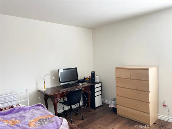 a bedroom with a bed and a desk