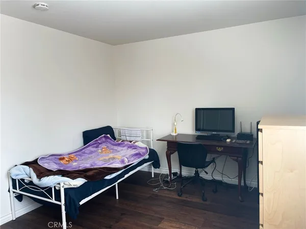 a bedroom with a bed and a desk
