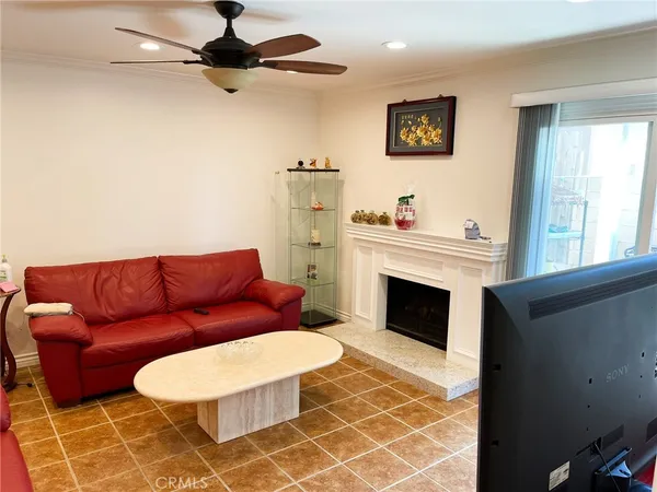 a living room with furniture a rug and a fireplace