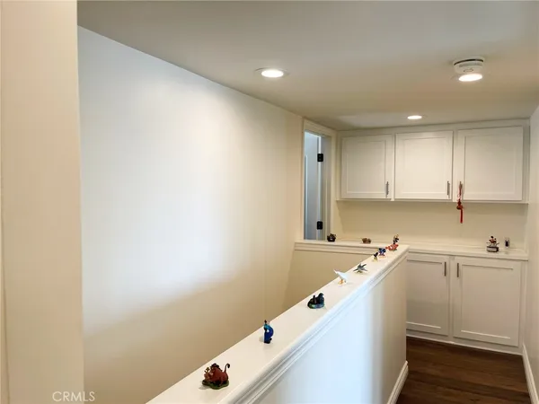 a room with a white cabinets and white appliances