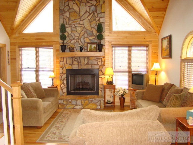 3075 Meat Camp Road Boone, NC 28607 - Photo 10 of 17 a living room with furniture fireplace and a large window