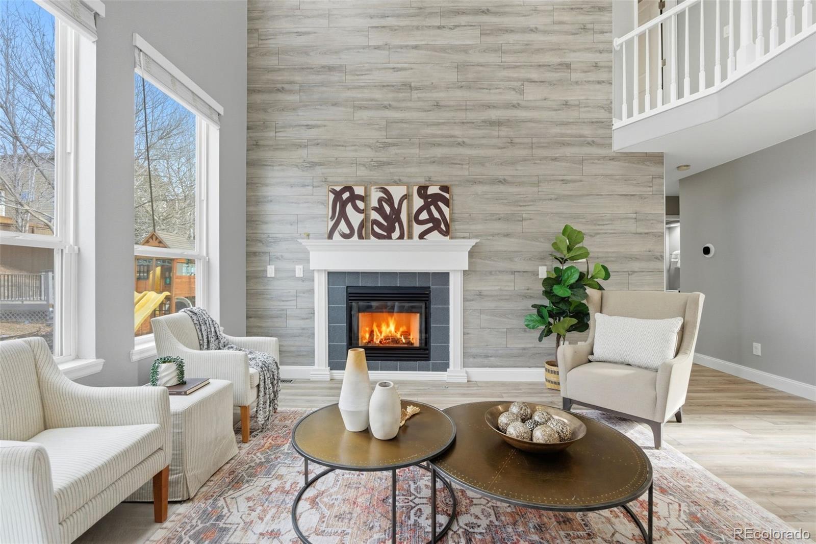 6621 Millstone Place Highlands Ranch, CO 80130 - Photo 17 of 48 a living room with furniture and a fireplace