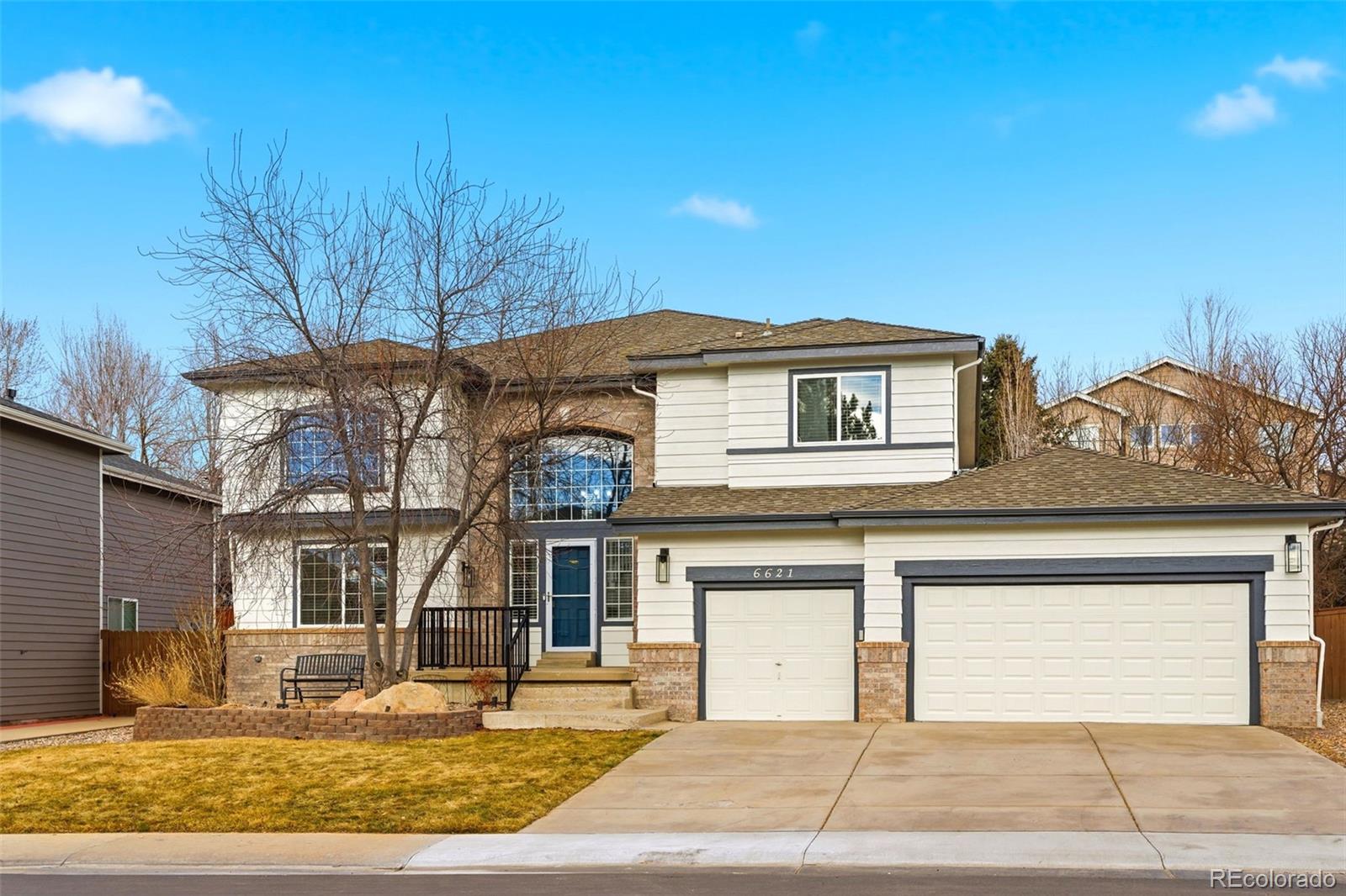 6621 Millstone Place Highlands Ranch, CO 80130 - Photo 2 of 48 a front view of a house with a yard
