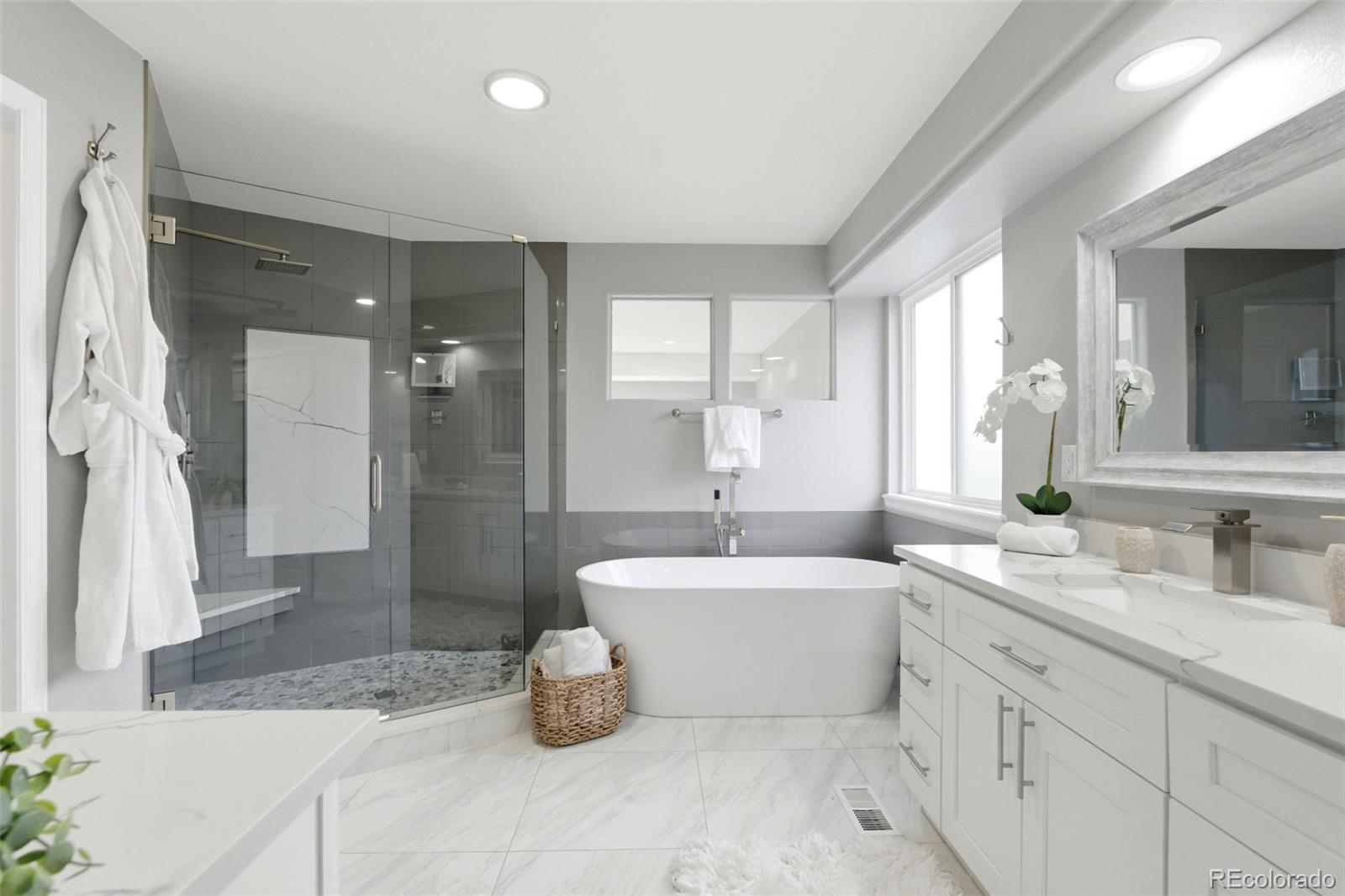 6621 Millstone Place Highlands Ranch, CO 80130 - Photo 29 of 48 a bathroom with a double vanity sink a toilet a mirror and shower
