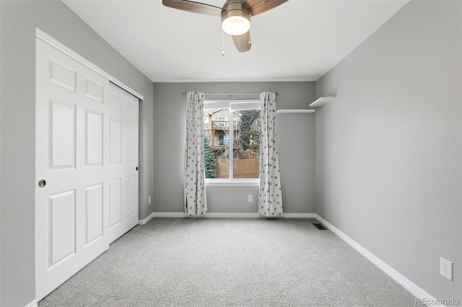 6621 Millstone Place Highlands Ranch, CO 80130 - Photo 32 of 48 a view of room with window and ceiling fan