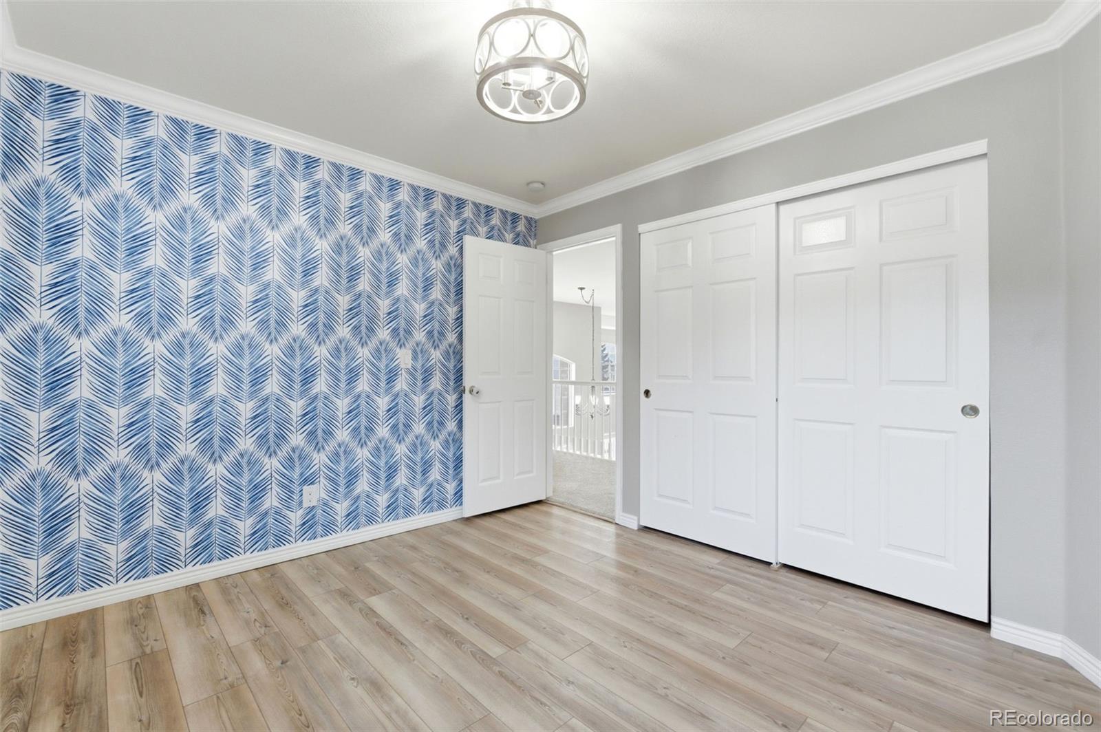 6621 Millstone Place Highlands Ranch, CO 80130 - Photo 35 of 48 a view of empty room with wooden floor and fan