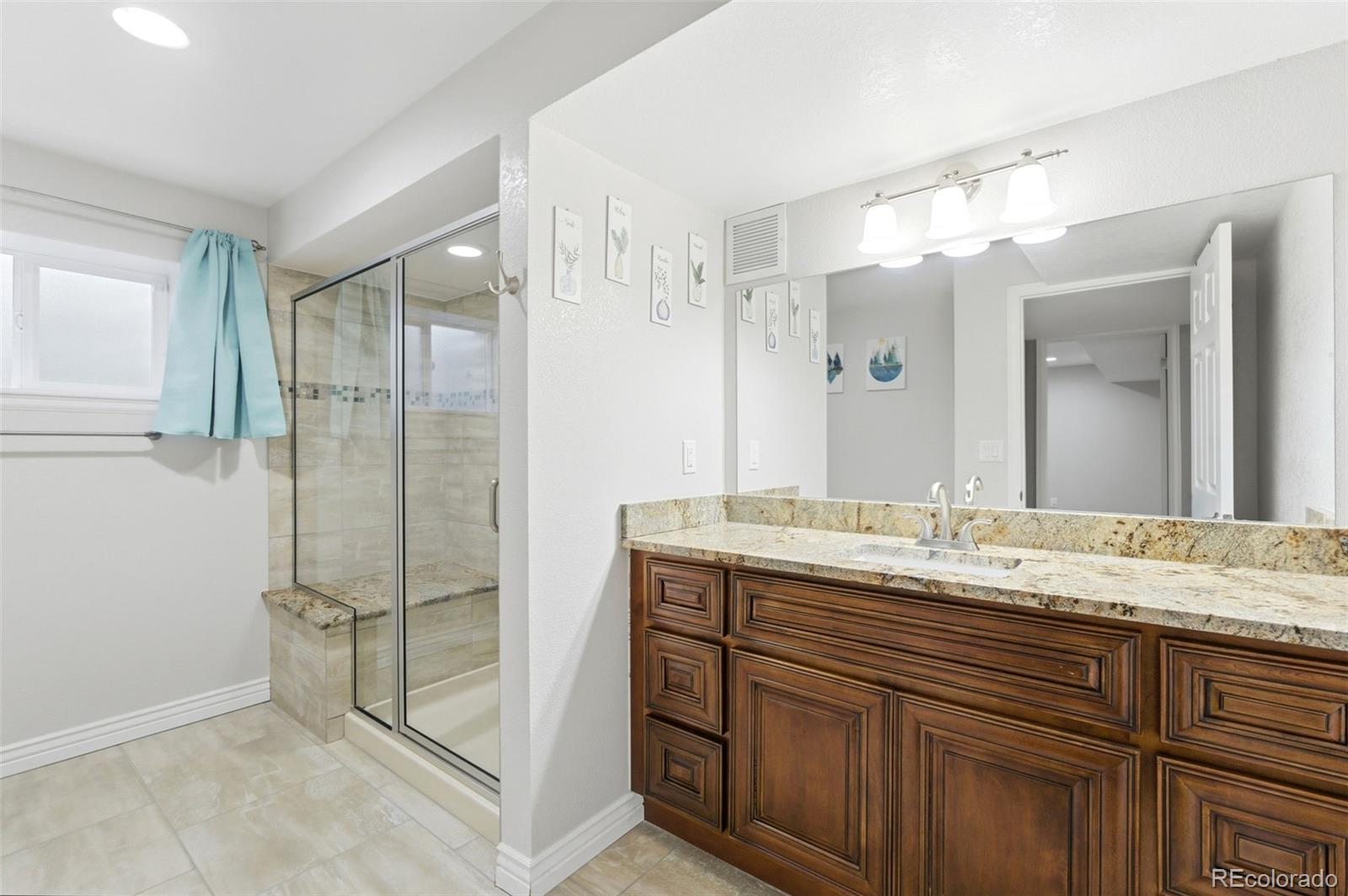 6621 Millstone Place Highlands Ranch, CO 80130 - Photo 42 of 48 a bathroom with a granite countertop sink mirror and double