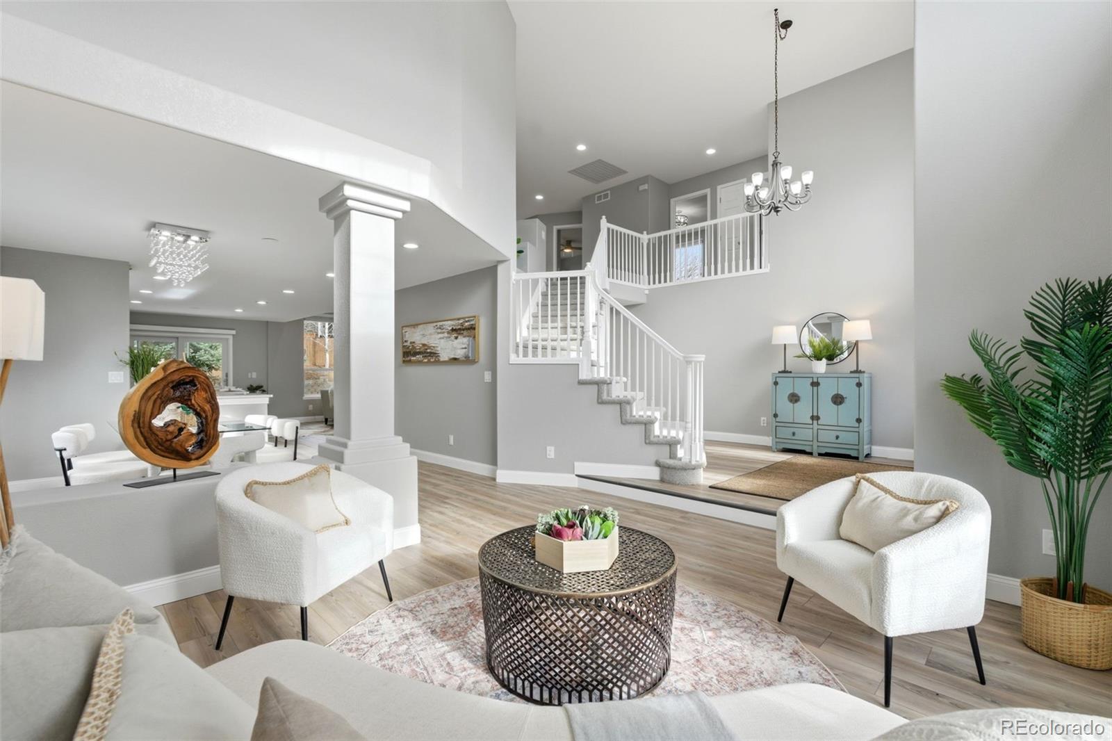 6621 Millstone Place Highlands Ranch, CO 80130 - Photo 5 of 48 a living room with furniture and a chandelier