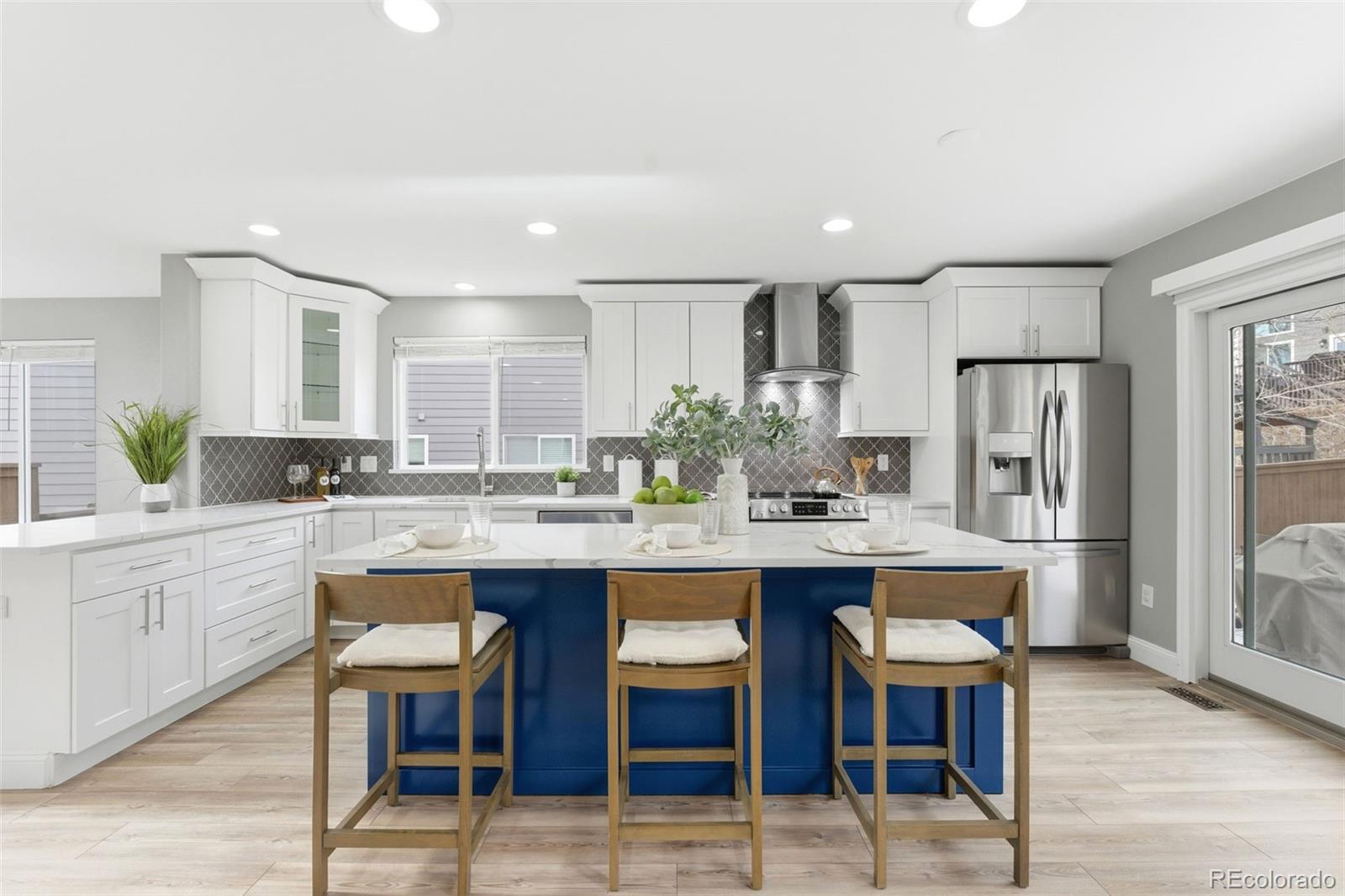 6621 Millstone Place Highlands Ranch, CO 80130 - Photo 10 of 48 a kitchen with stainless steel appliances granite countertop a table and chairs in it