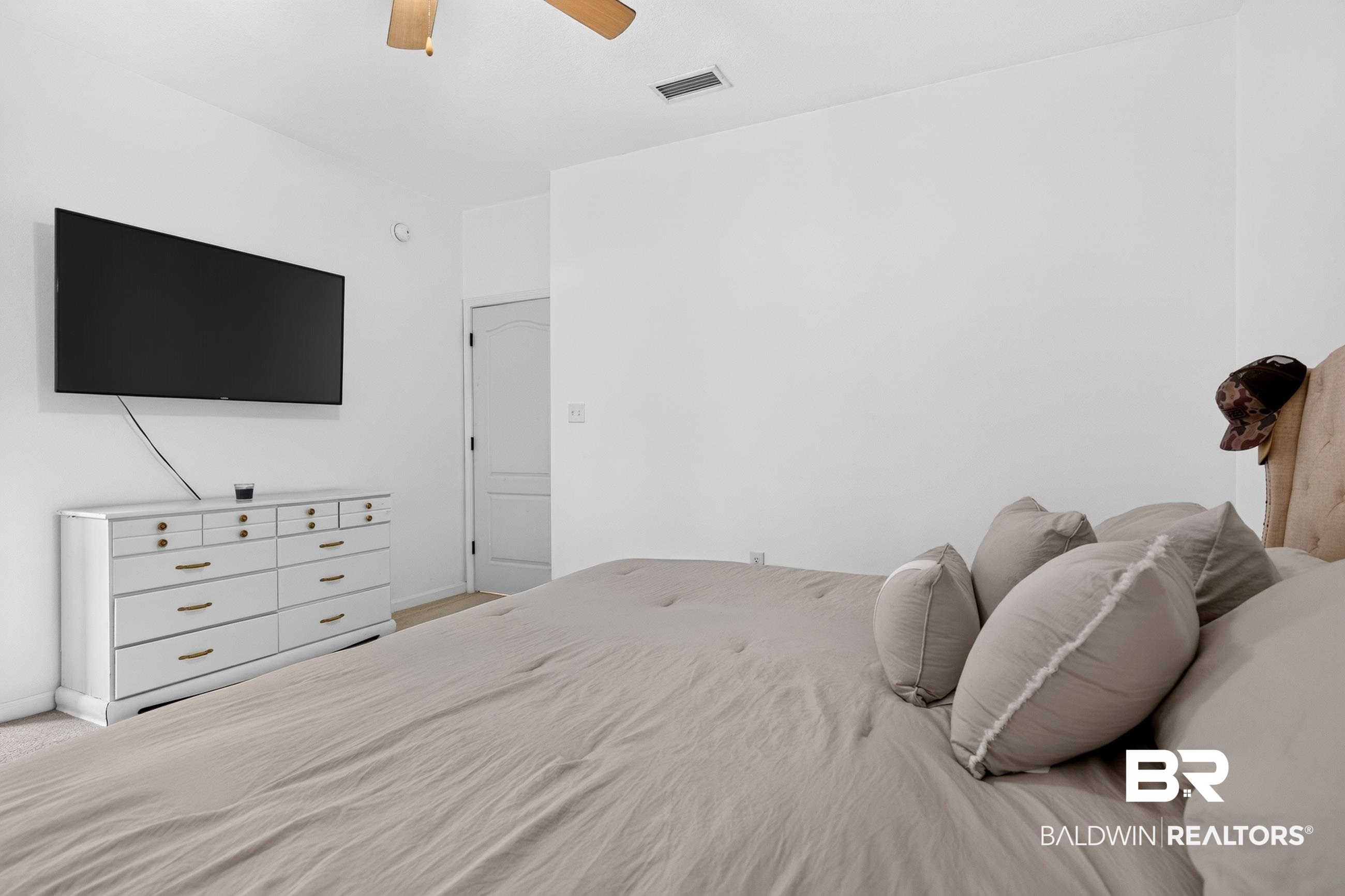 17419 Lewis Smith Drive Foley, AL 36535 - Photo 22 of 38 Bright interior space with white walls and light-colored carpeting
