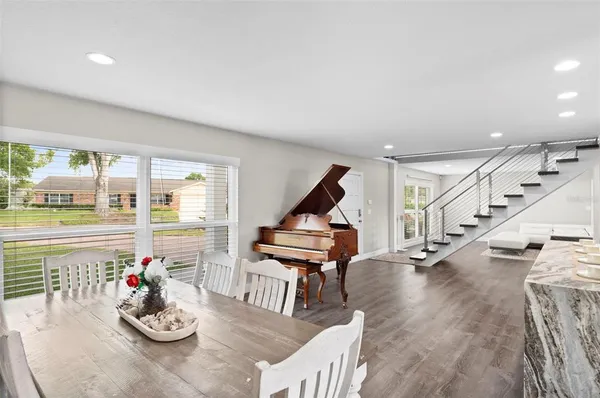 a view of a livingroom with wooden floor and a fireplace