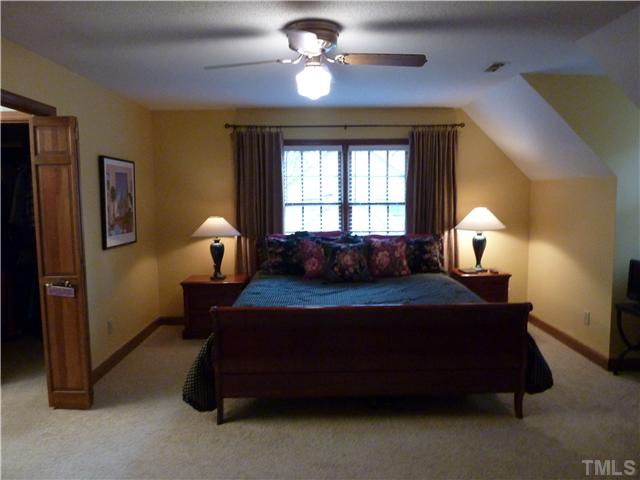 1924 Wilton Circle Raleigh, NC 27615 - Photo 12 of 22 a bedroom with a bed and a chandelier