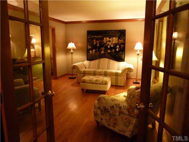 1924 Wilton Circle Raleigh, NC 27615 - Photo 3 of 22 a bedroom with a bed and wooden floor