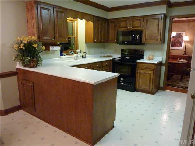 1924 Wilton Circle Raleigh, NC 27615 - Photo 6 of 22 a kitchen with a sink and a stove top oven