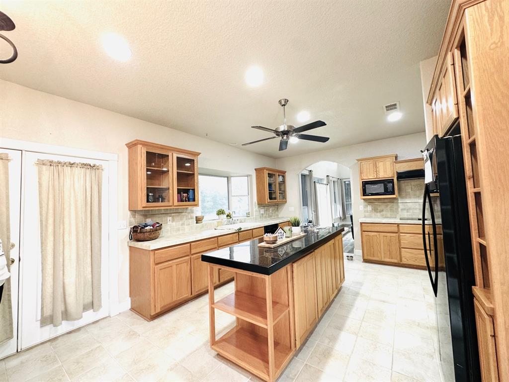 400 Indian Hills Road Gatesville, TX 76528 - Photo 15 of 38 a kitchen with stainless steel appliances granite countertop a stove and a sink
